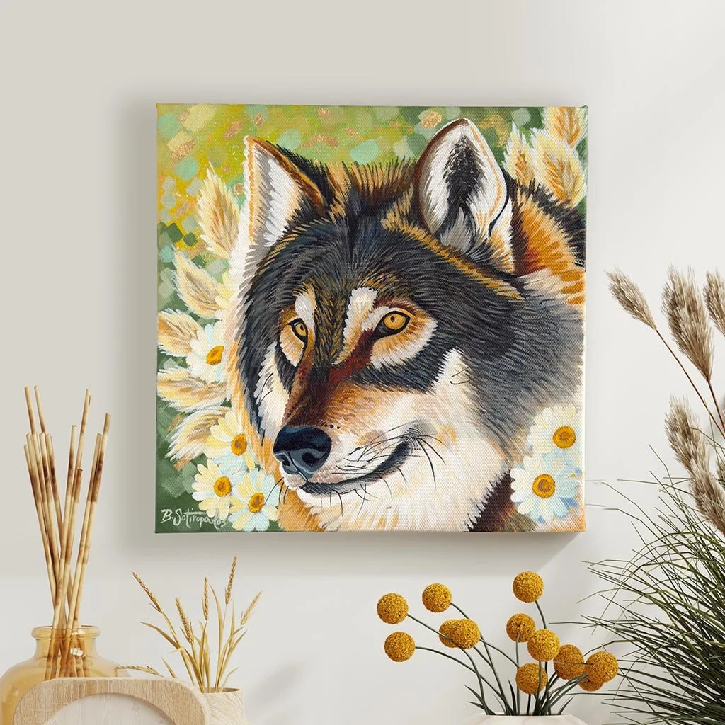 A person wearing a light blue shirt using a laptop and holding a credit card, sitting at a desk with papers.