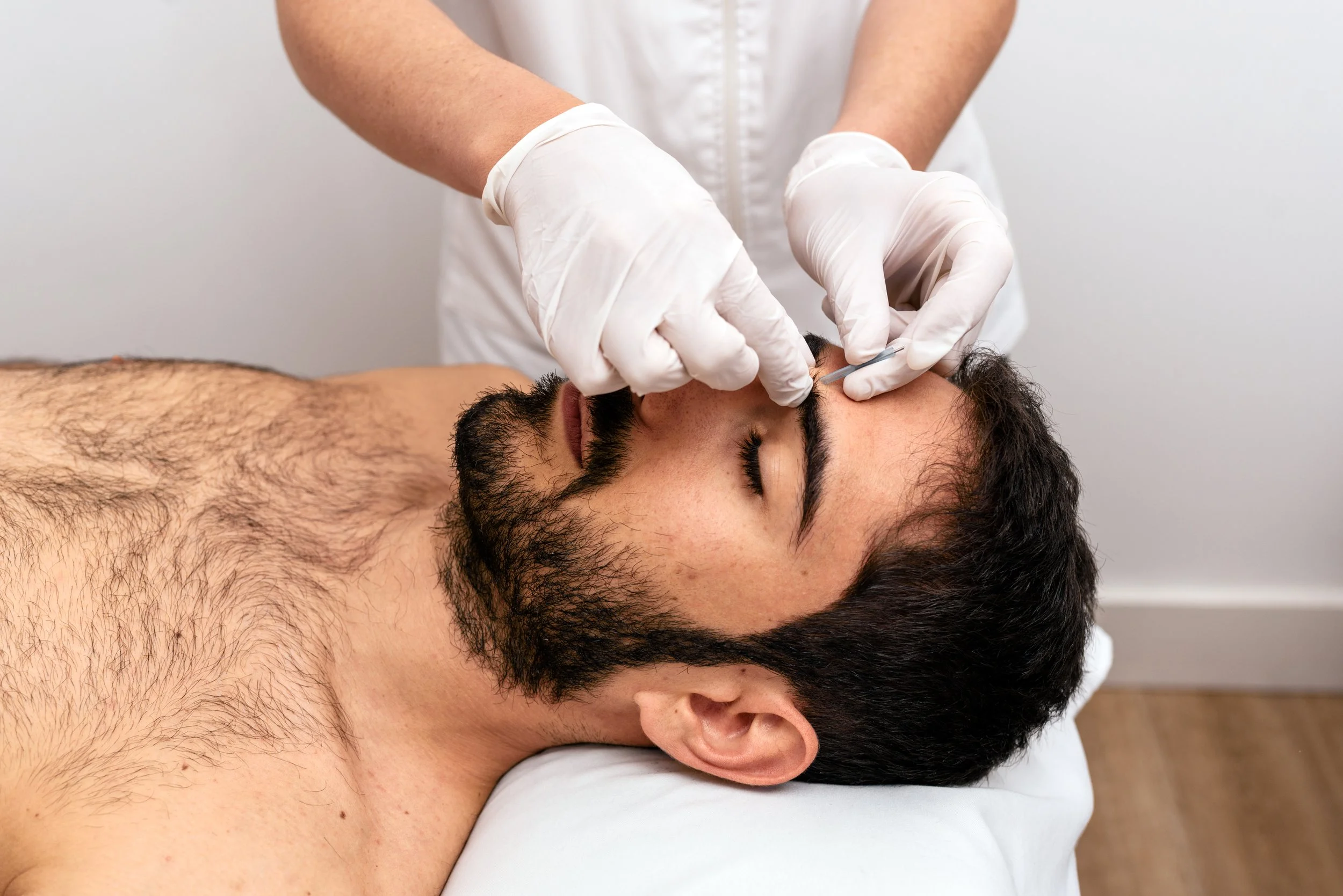Gentleman’s express waxing: eyebrow waxing in progress