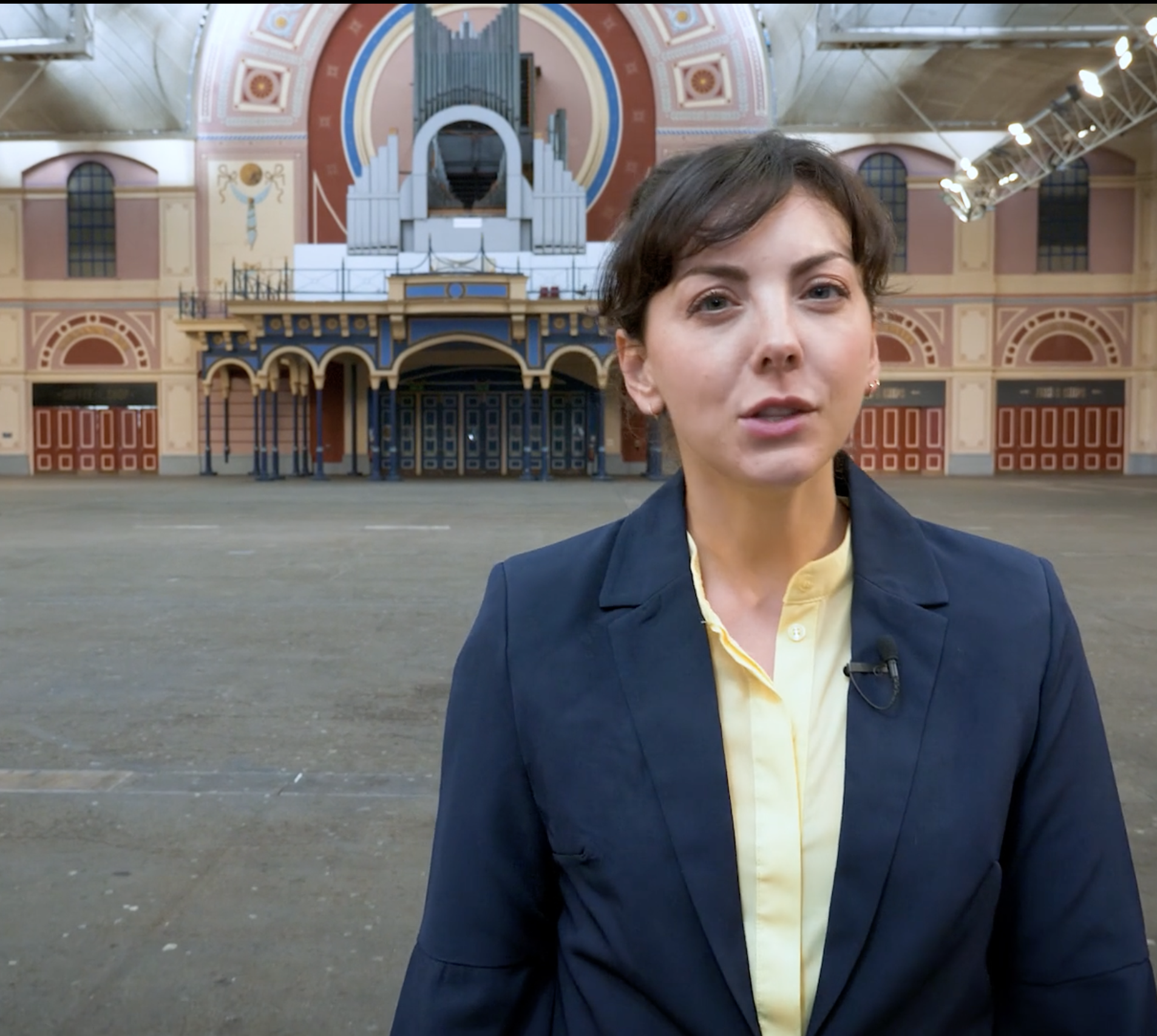 A woman standing in the main hall of Alexandra Palace