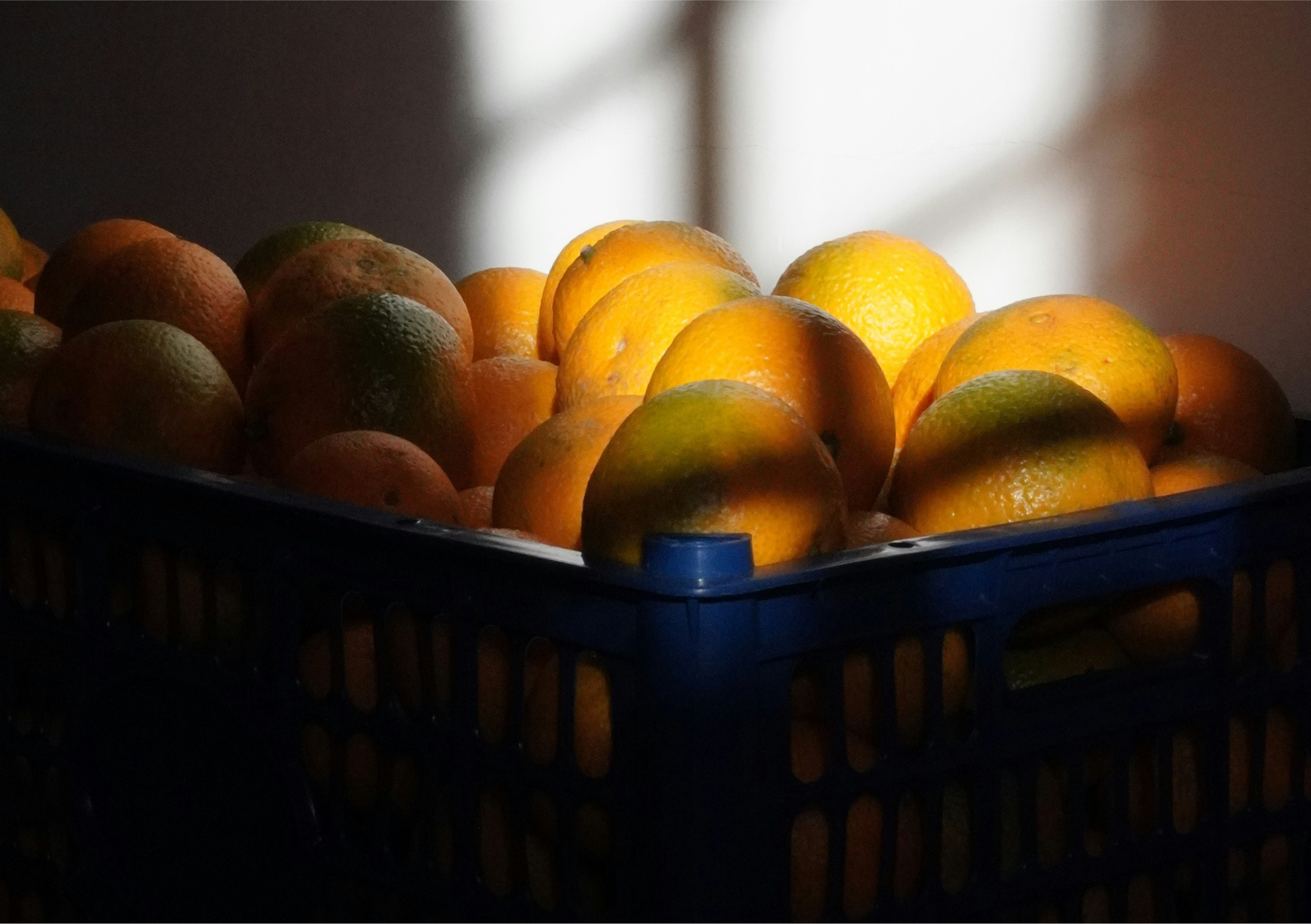 A communal crate of oranges