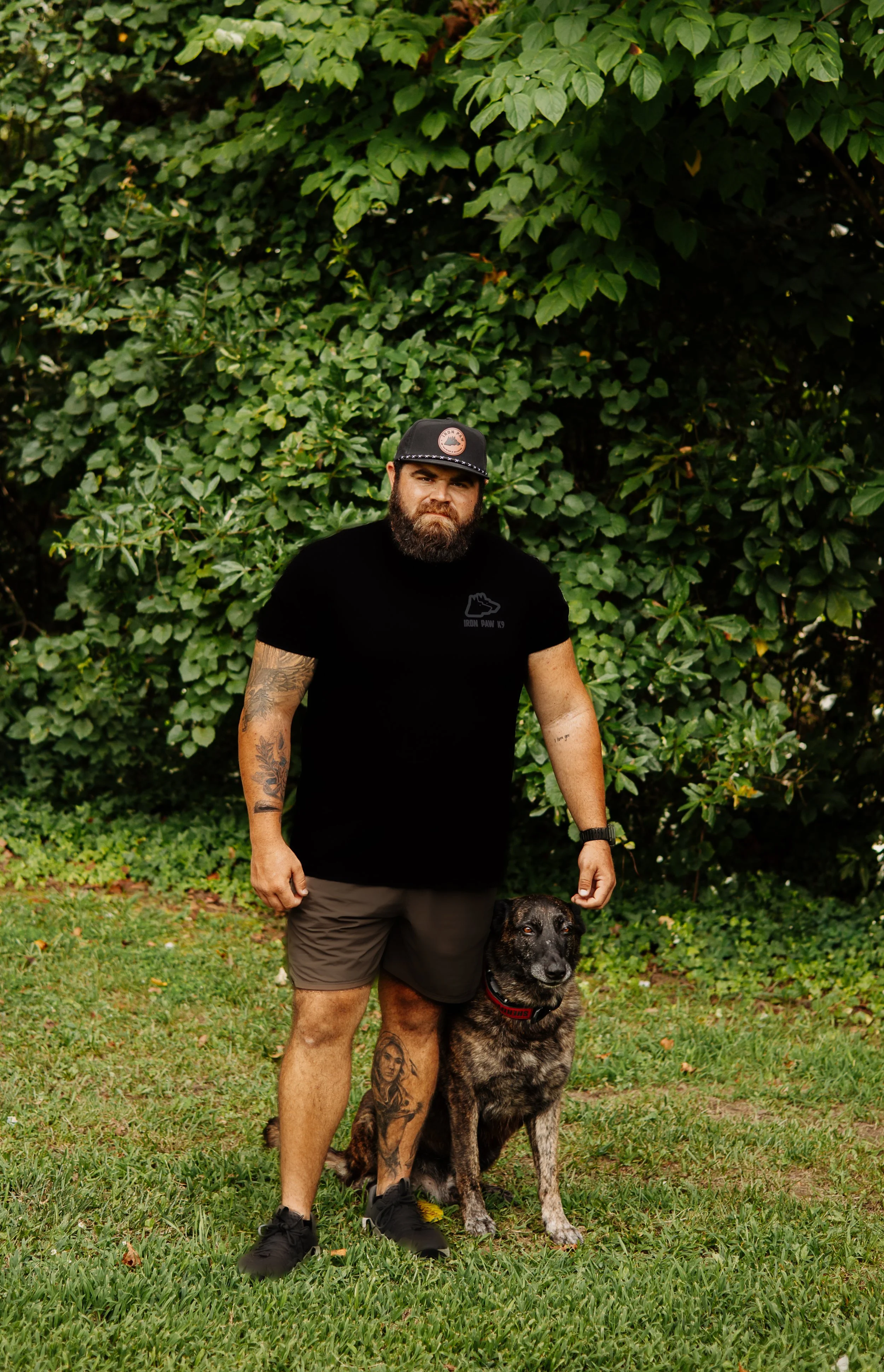Iron Paw K9 owner Blake Forrester with a trained Dutch Shepherd at his professional dog training facility in Hall County, GA.