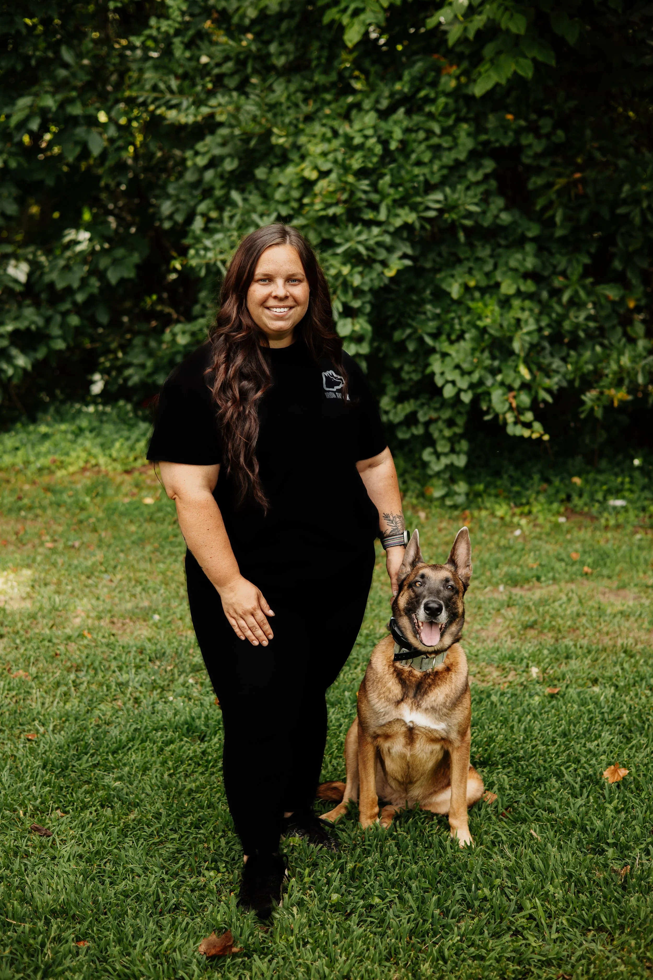 Sarah Forrester of Iron Paw K9 standing with a trained working dog at the Hall County, Georgia training facility.