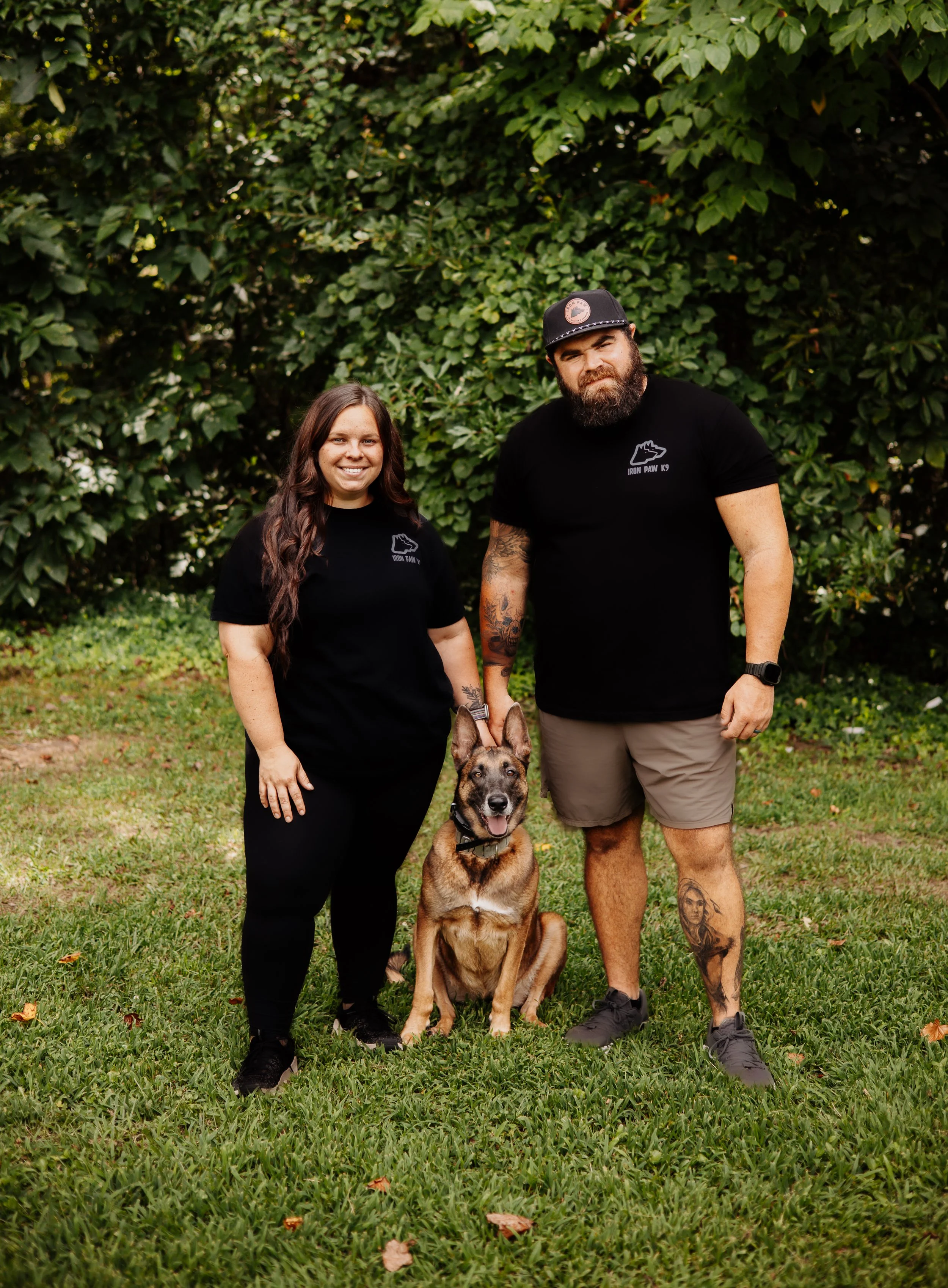 Professional dog trainers Blake and Sarah Forrester with a Belgian Malinois at Iron Paw K9 serving Hall County, Atlanta, and surrounding areas.