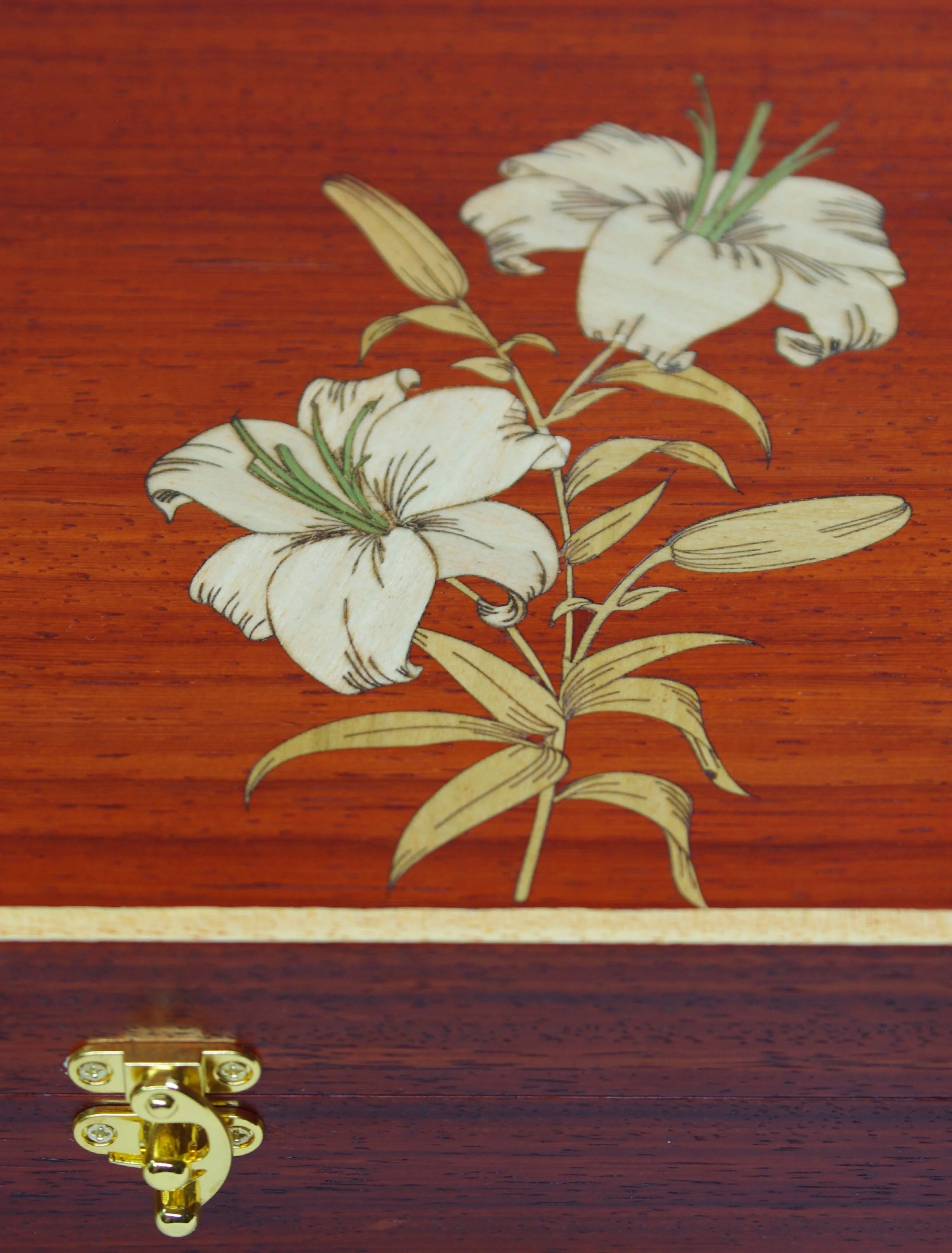 Jewellery box in Paduak with inlaid lilies.