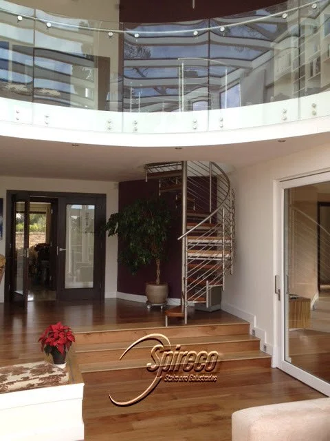 ‘WalnutFlute’ model Spiral Stairs.
Polished Stainless Steel Frame, Handrail, Posts, Rods & connectors with 2″ Walnut Treads and Quater Circle Landing.