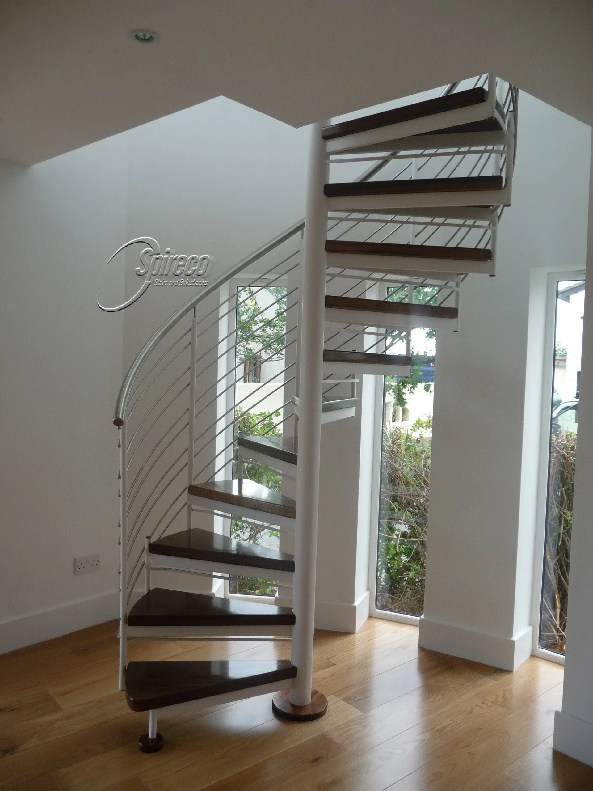 ‘Dune Slipstream’ Spiral Stairs.
‘Slipstream’ model Spiral Stairs with Stainless Steel Handrail and Rod Balustrade and 2″ thick Walnut treads.