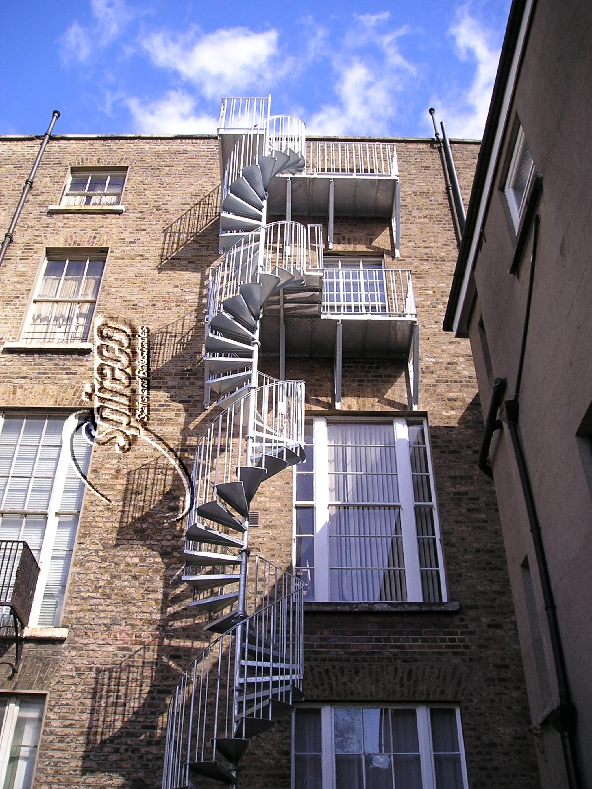 Fitzwilliam Square Spiral Escape Stair.
5 Storey Galvanised Spiral Stair & Landings Fire Escape with chequer plate treads.