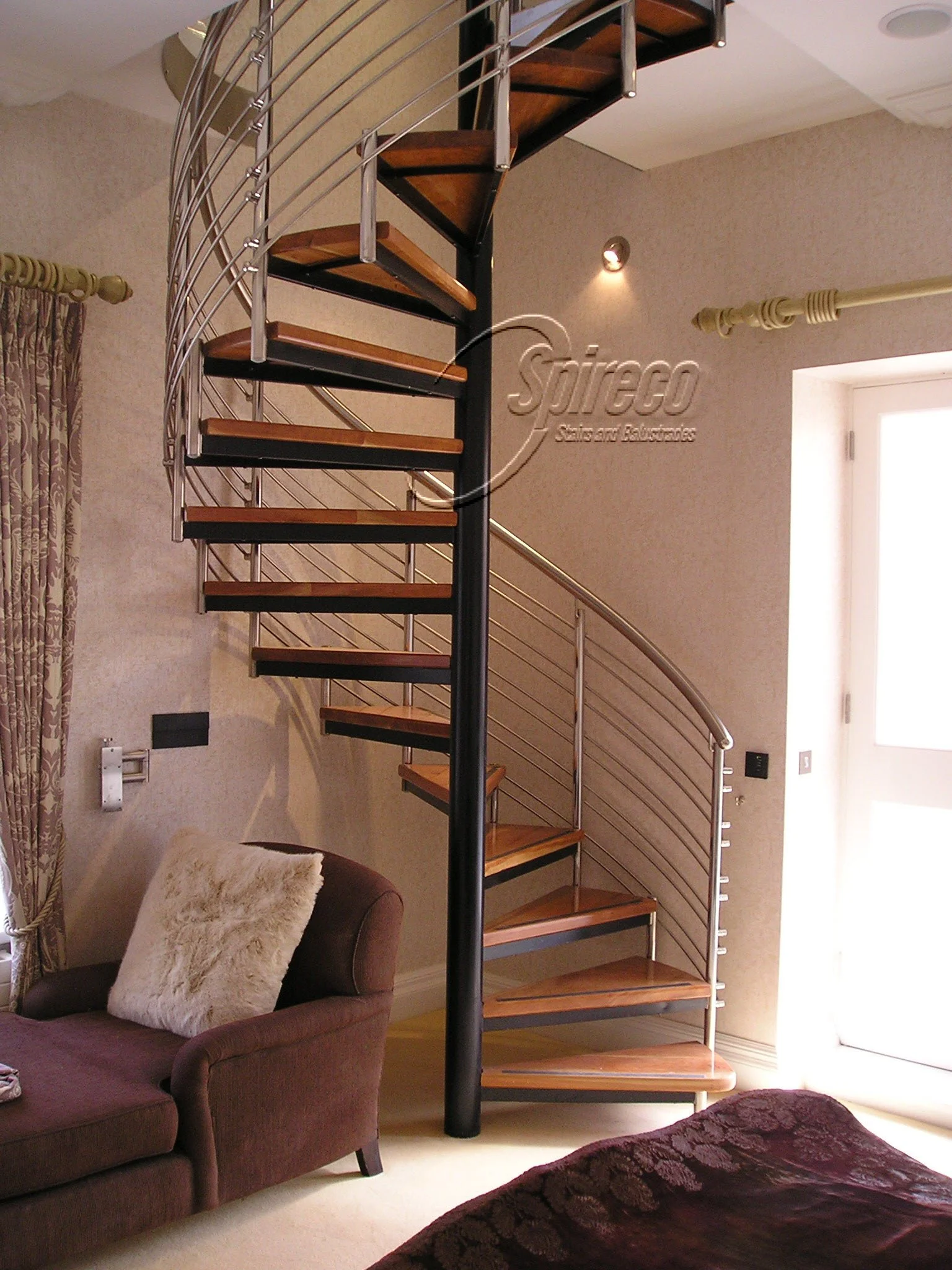 ‘Howth Lodge’ Viola style Spiral Stairs.
Tubular Stainless Steel Handrail & Post Balustrade with Stainless Steel Rods & Connectors on Black steel frame with 2″ thick Cherry treads.