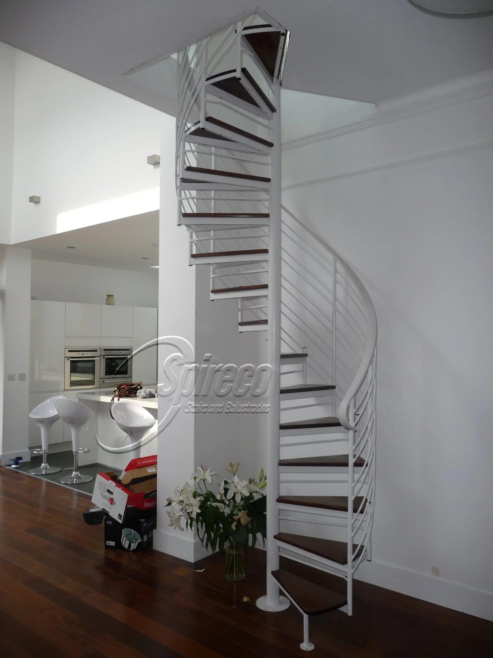 ‘Room to Improve’ Helix Spiral Stairs.
White ‘Helix’ style Spiral Stairs with Dark mahogany Treads and White Handrail.