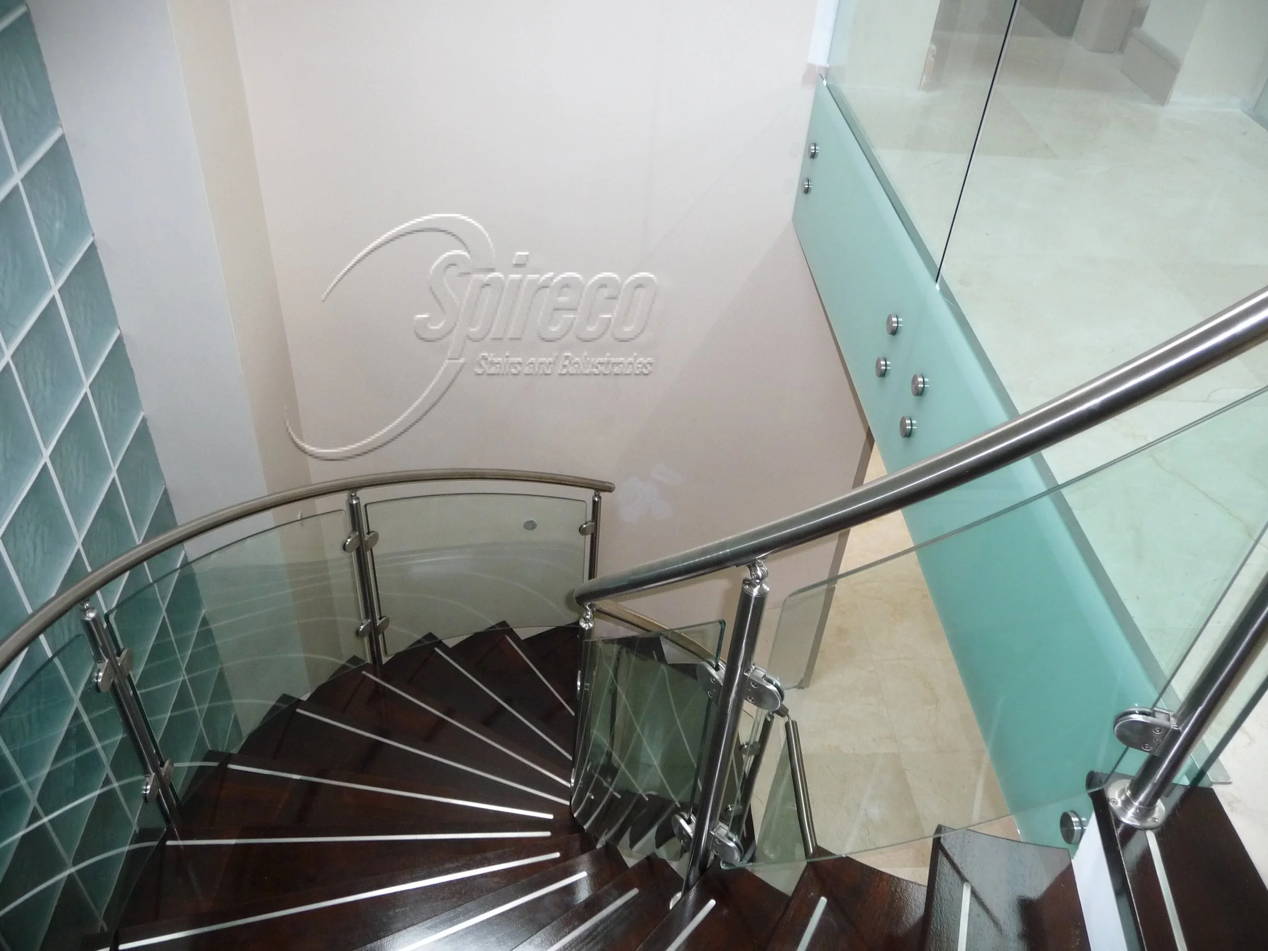 ‘McCreadies’ Balustrades.
Curved Stainless Steel and Glass Balustrades with Opal glass facias, Hardwood treads with inset Stainless Steel grip, slotted Stainless Steel handrail on landing glass balustrade.