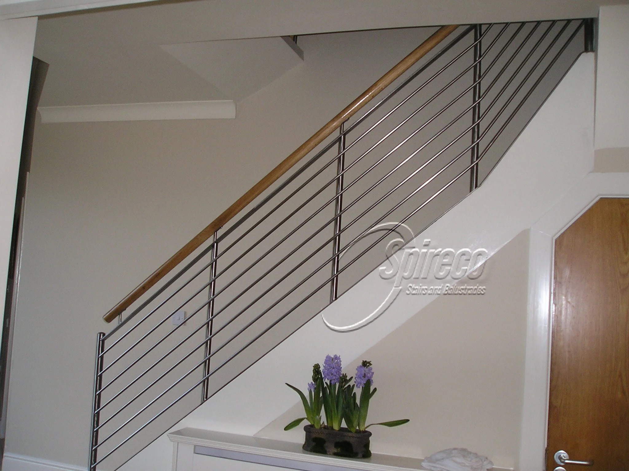 ‘Titania’ Stainless Steel Balustrade.
Stainless Steel raking rod Balustrade with Oak Handrail.