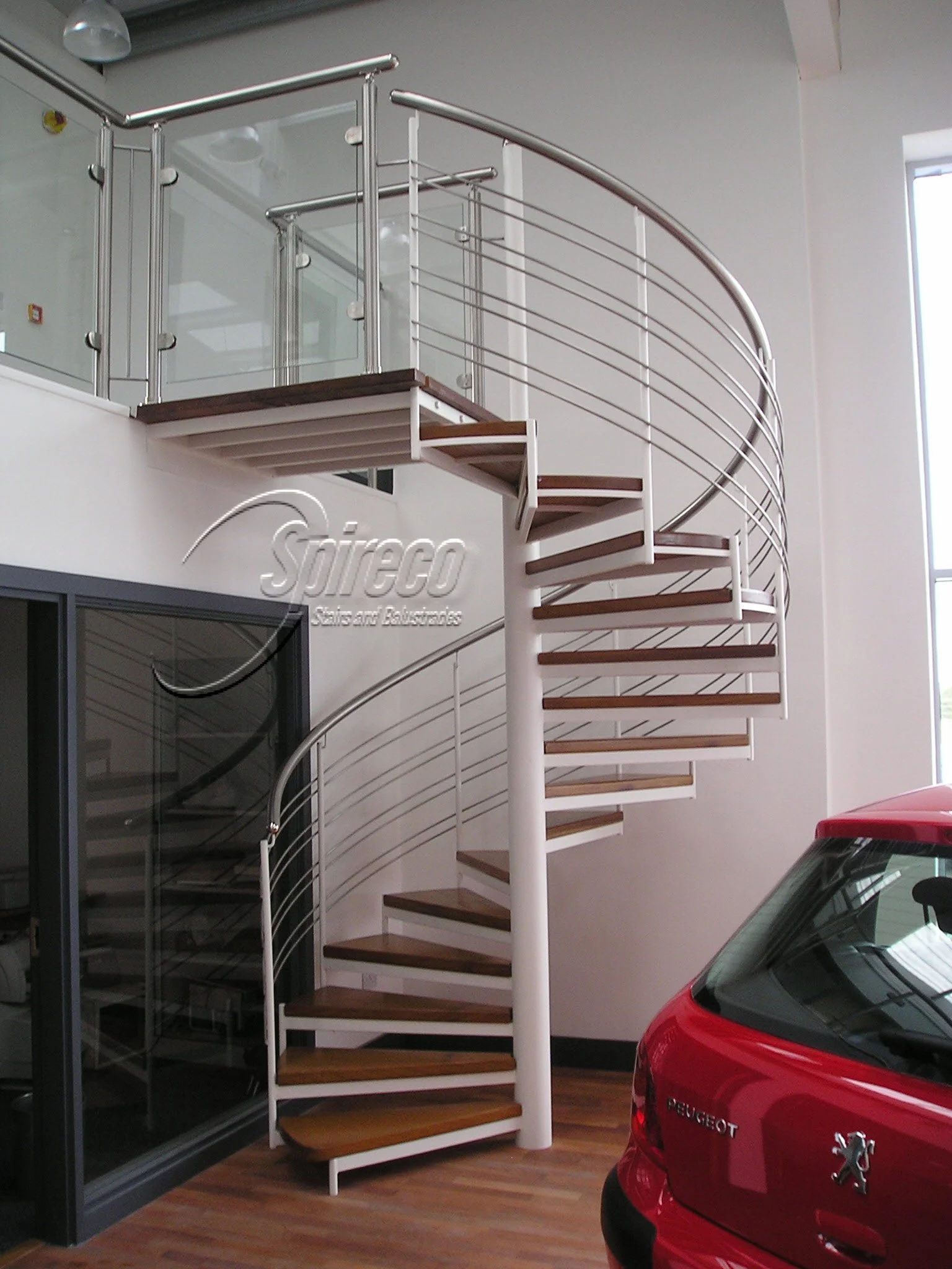 ‘Peugeut’ Slipstream Spiral Stairs.
‘Slipstream’ Spiral Stairs with Oak Treads & Landing and Stainless Steel & Glass Landing Balustrade.