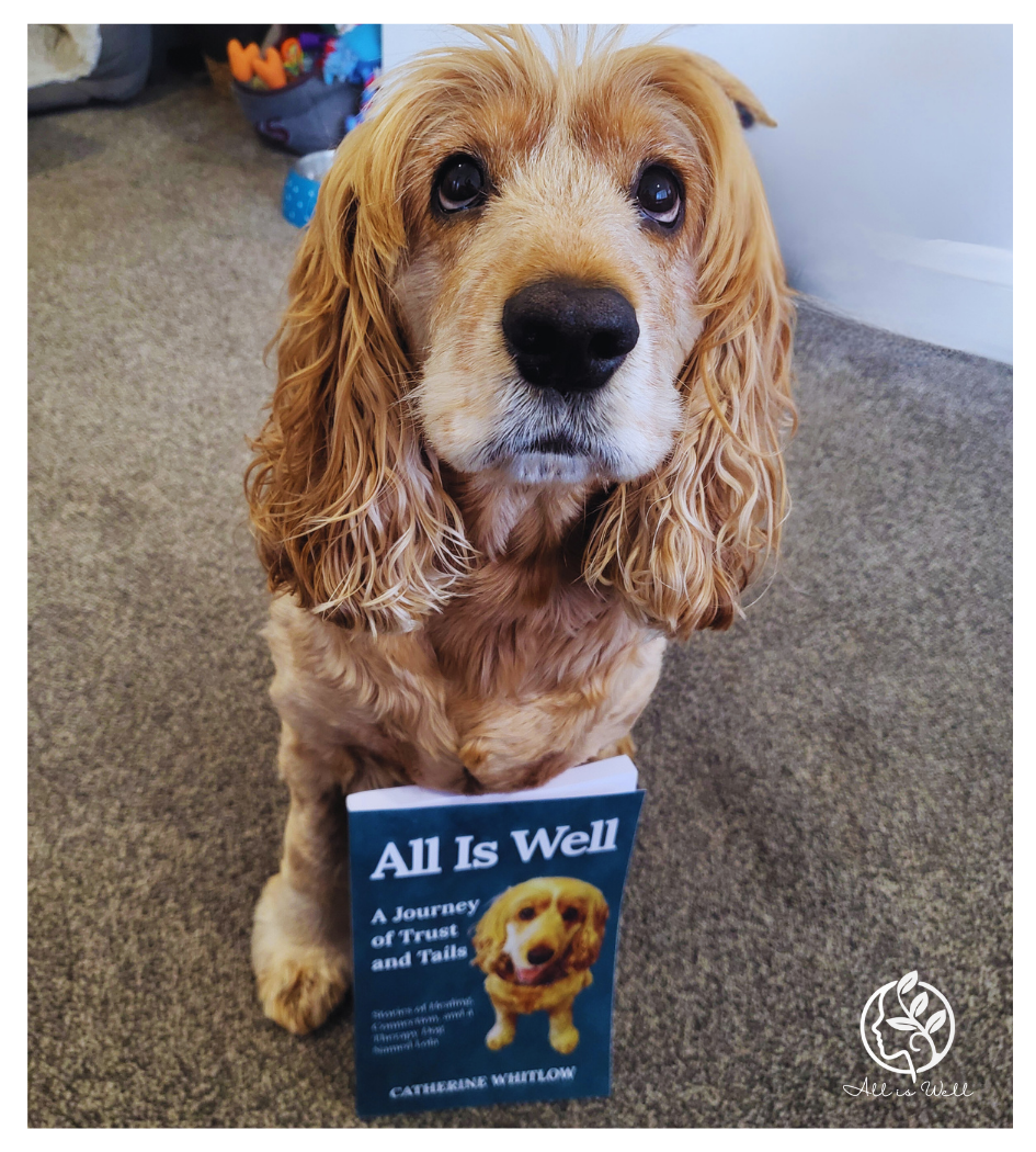 Therapy Dog Lola sitting with her book