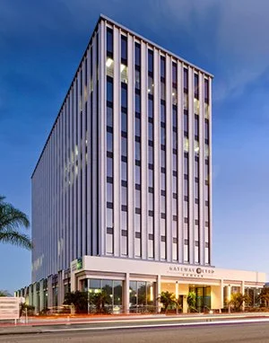 Tall modern office building with a glass and concrete facade, labeled Gateway Center.