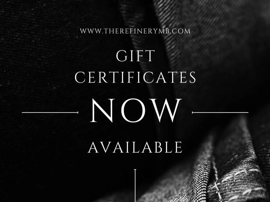Several black gift boxes wrapped with gold ribbons and bows arranged on a black background.