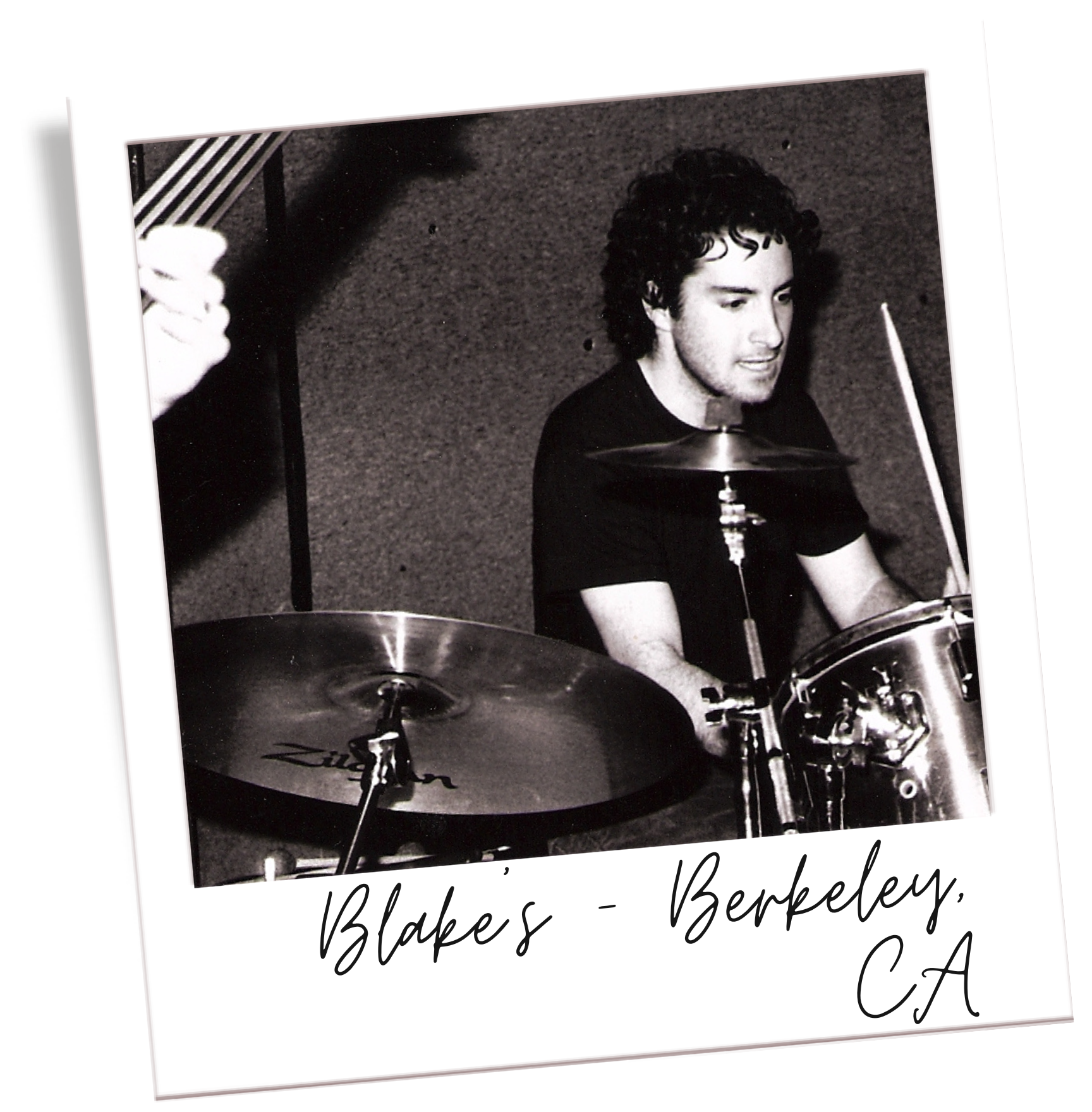 Black and white photograph of a young man with curly hair playing drums, with handwritten text below the photo reading "Blake's - Berkeley, CA."