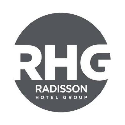 Logo of RHG Radisson Hotel Group in a dark circle