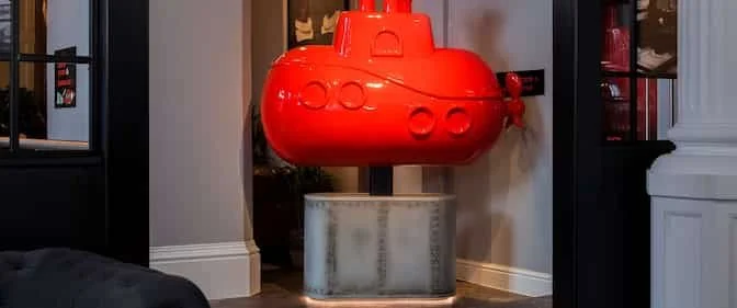 A red submarine model on display in a room.