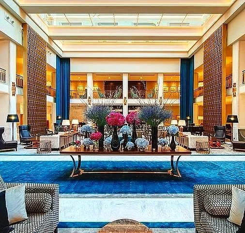 Elegant hotel lobby with floral arrangement and seating area