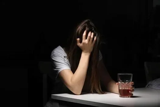 close-up-of-woman-sitting-and-holds-glass-with-whiskey-or-cognac-having-alcohol-addiction-depressed-female-drinking-strong-alcohol-suffering-from-personal-relationships-problems-photo.webp