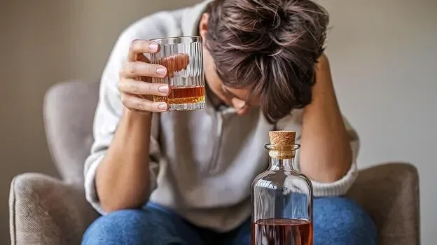 person-struggling-with-alcohol-addiction-holding-a-glass-of-whiskey-feeling-hopeless-and-alone-in-free-photo.webp