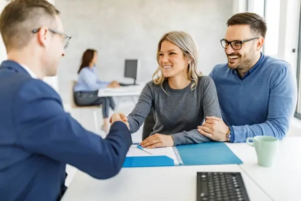 happy-couple-came-to-an-agreement-with-their-financial-advisor-in-the-office.webp