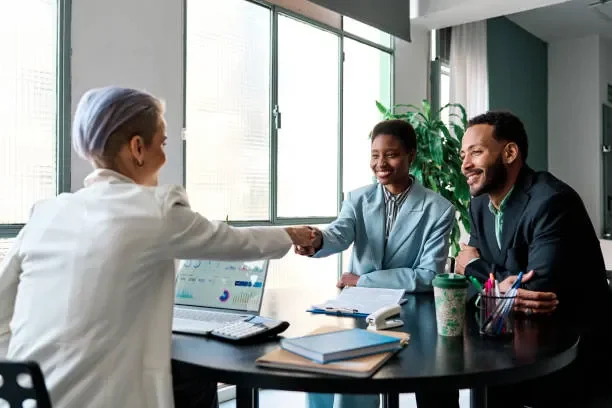 businesswoman-closing-a-deal-with-clients.webp