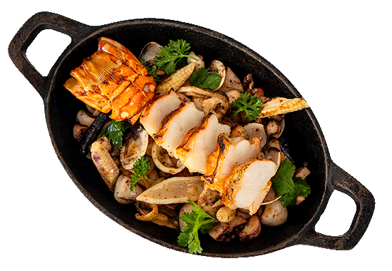 Seafood platter with lobster tail, scallops, shrimp, and garnished with cilantro in a black serving dish.