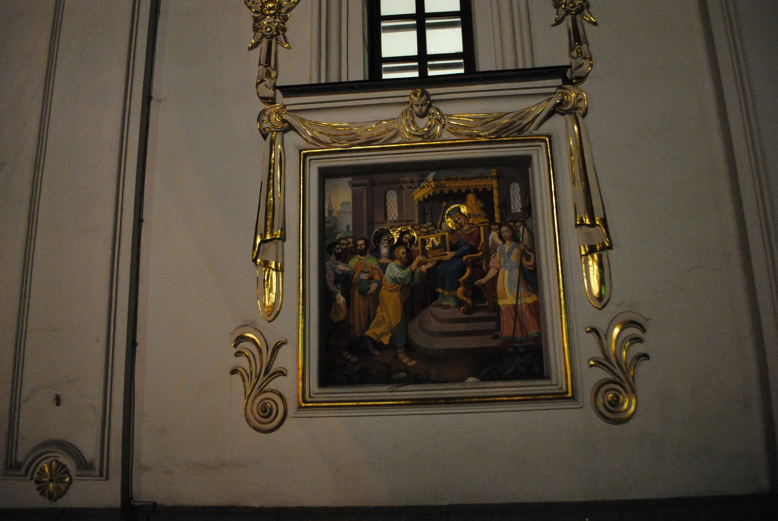 A religious artwork depicting a scene with Jesus Christ, surrounded by people, inside a church with ornate gold and white framing.