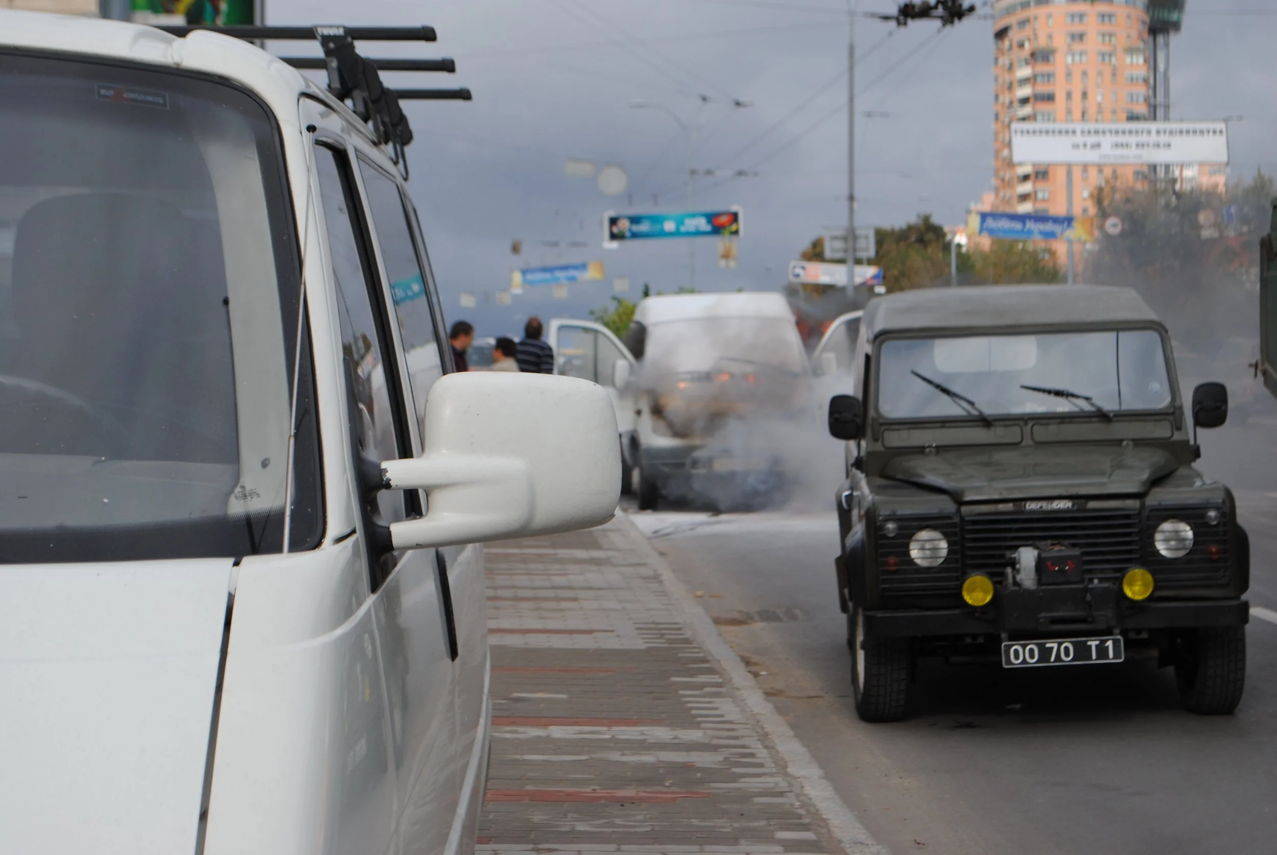 Street scene with vehicles and pedestrians, overcast sky, in an urban area. Kiev November 2011, Marina Parrish ©