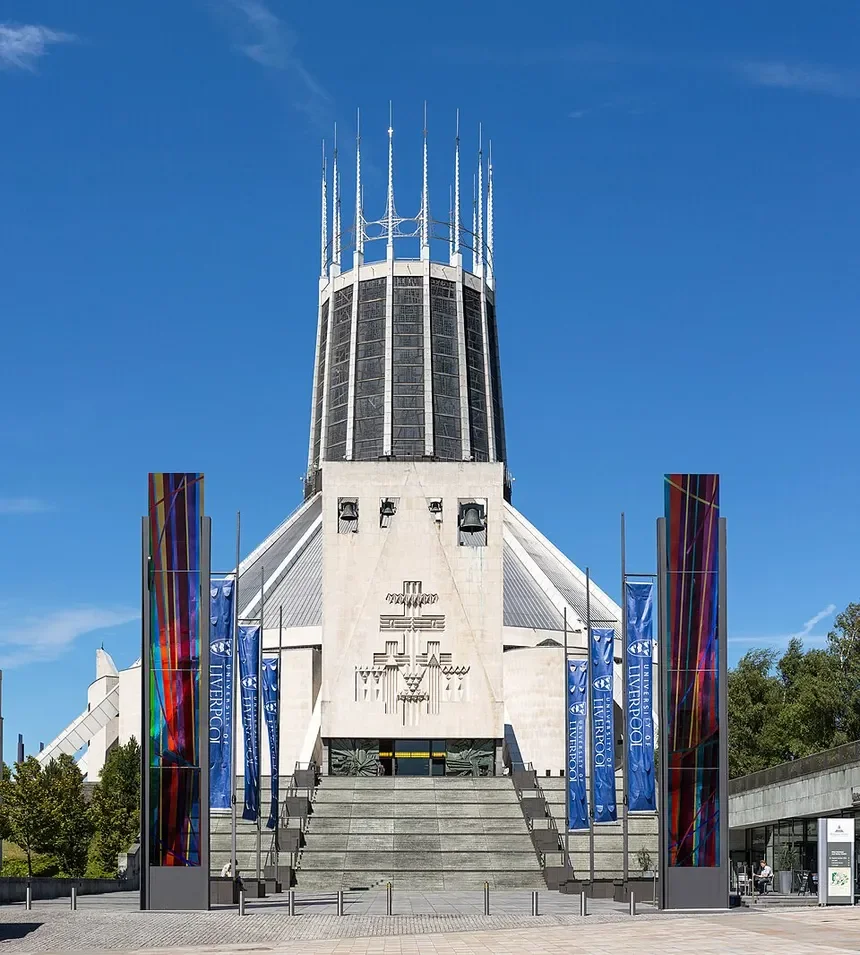 The building is the Metropolitan Cathedral of Liverpool with blue skies in the background.
