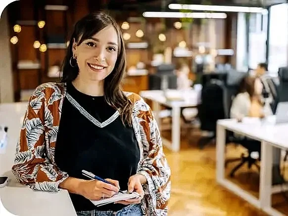 A cute bulldog lying on a neatly made bed with white sheets in a modern bedroom.