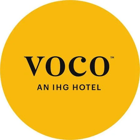Yellow circle with the words 'voco' and 'an IHG hotel' in black text.