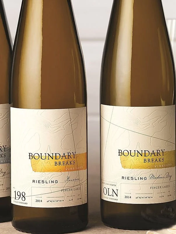 Two bottles of Boundary Breaks Riesling wine with white labels and yellow artwork, placed side by side