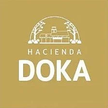 Logo with illustration of a farm scene and text 'HACIENDA DOKA' in white on a gold background.