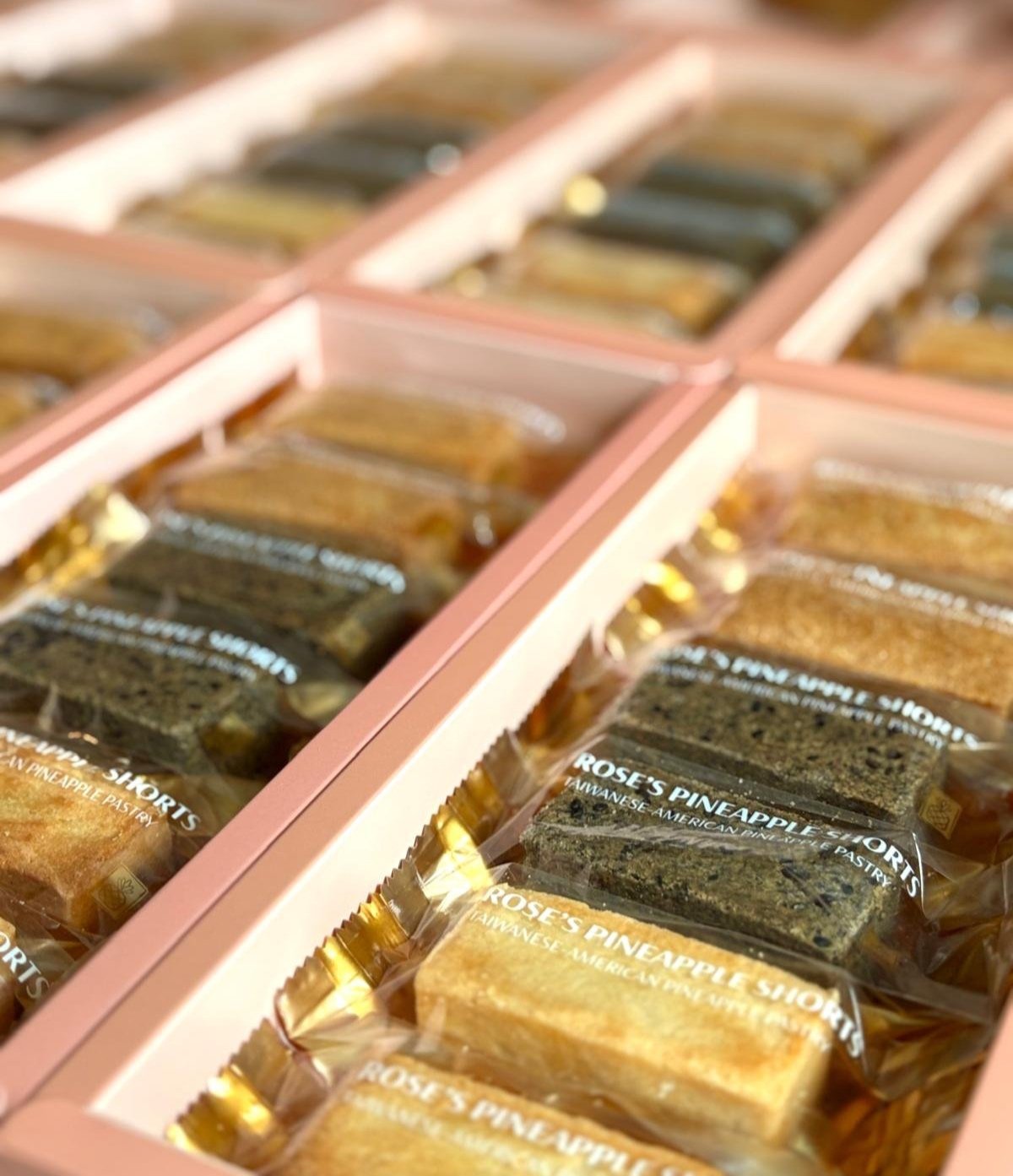 Box of assorted pineapple pastries labeled 'Rose's Pineapple Shorts' and 'Rose's Pineapple'.