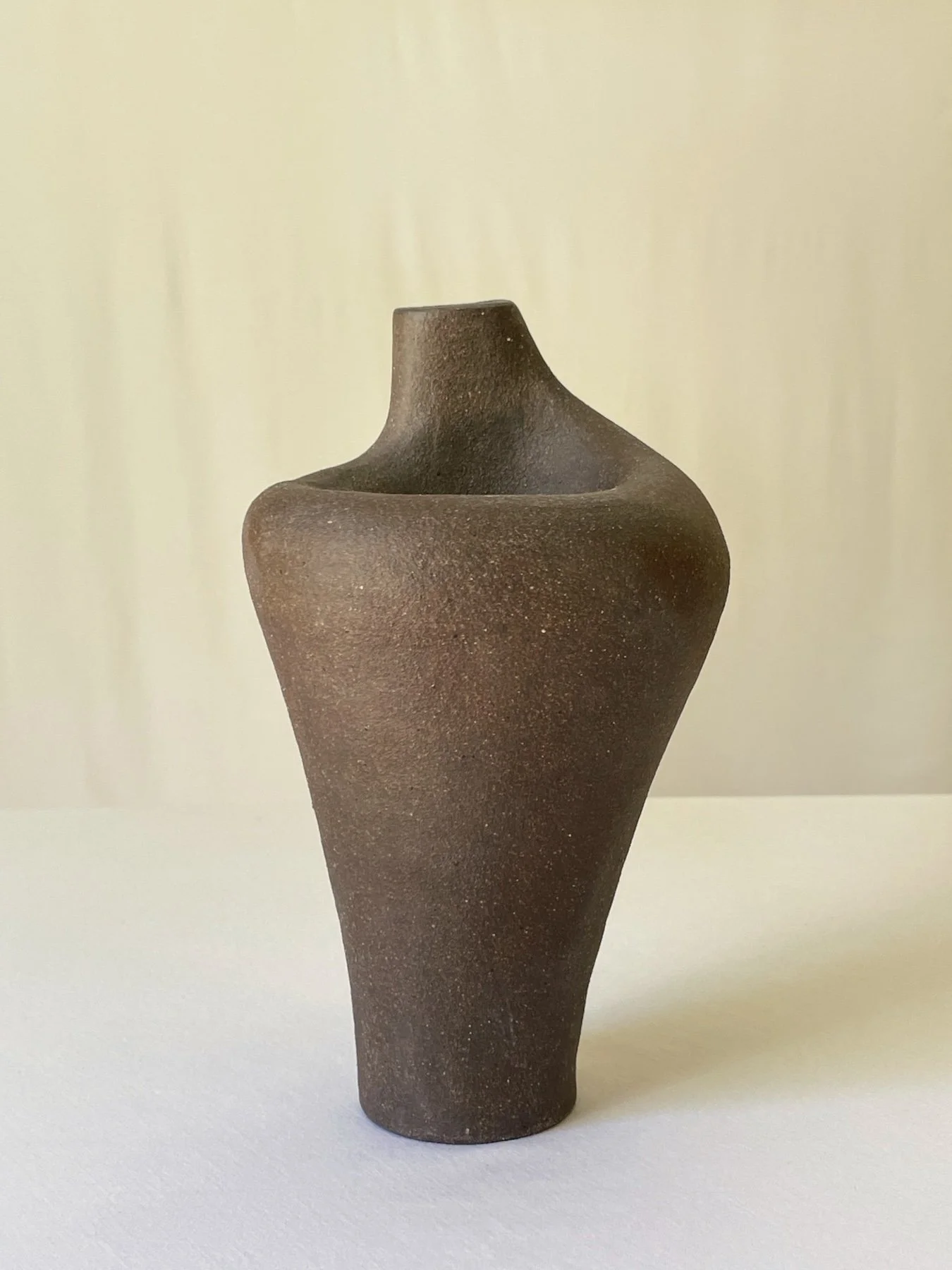 dark clay sculpture with a divot