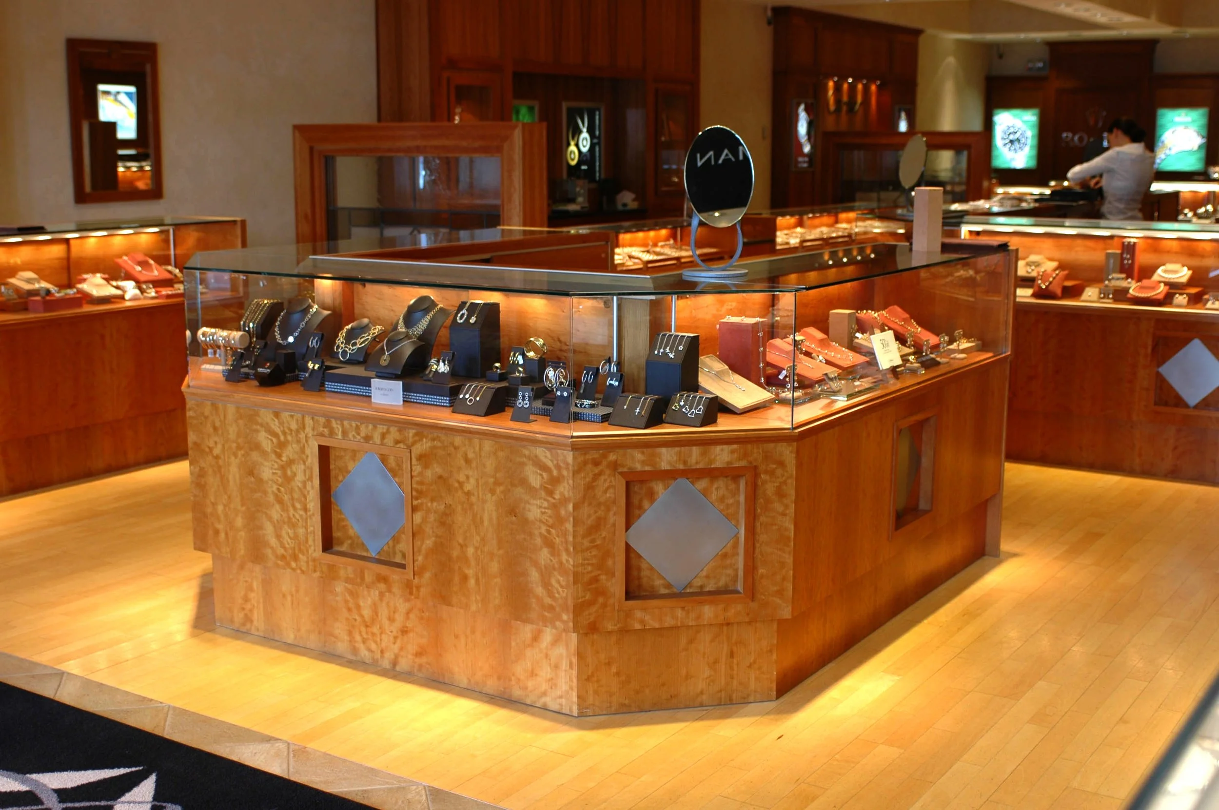 Honey-colored figured cherry, custom built wooden jewelry display cases for Frank Adams Jewelers.