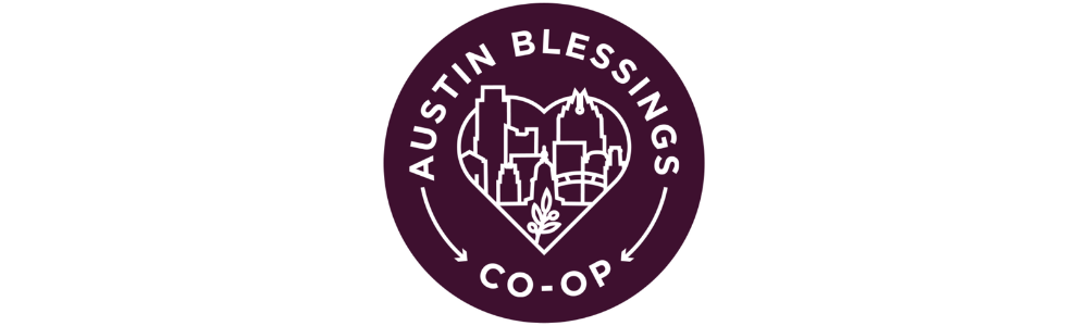 A person skateboarding on a wooden ramp in a park with green trees in the background.