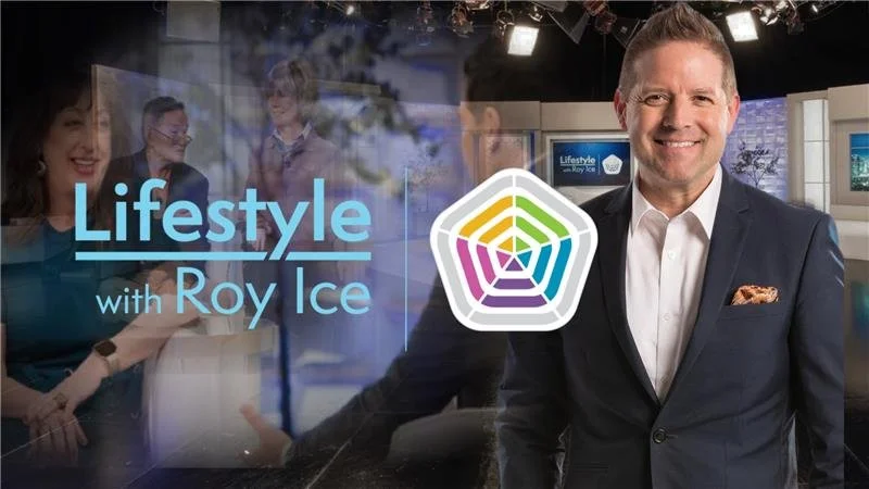 Television studio set with a man in a suit smiling, behind him is the 'Lifestyle with Roy Ice' logo and a glass window showing a blurred image of a woman and two men.