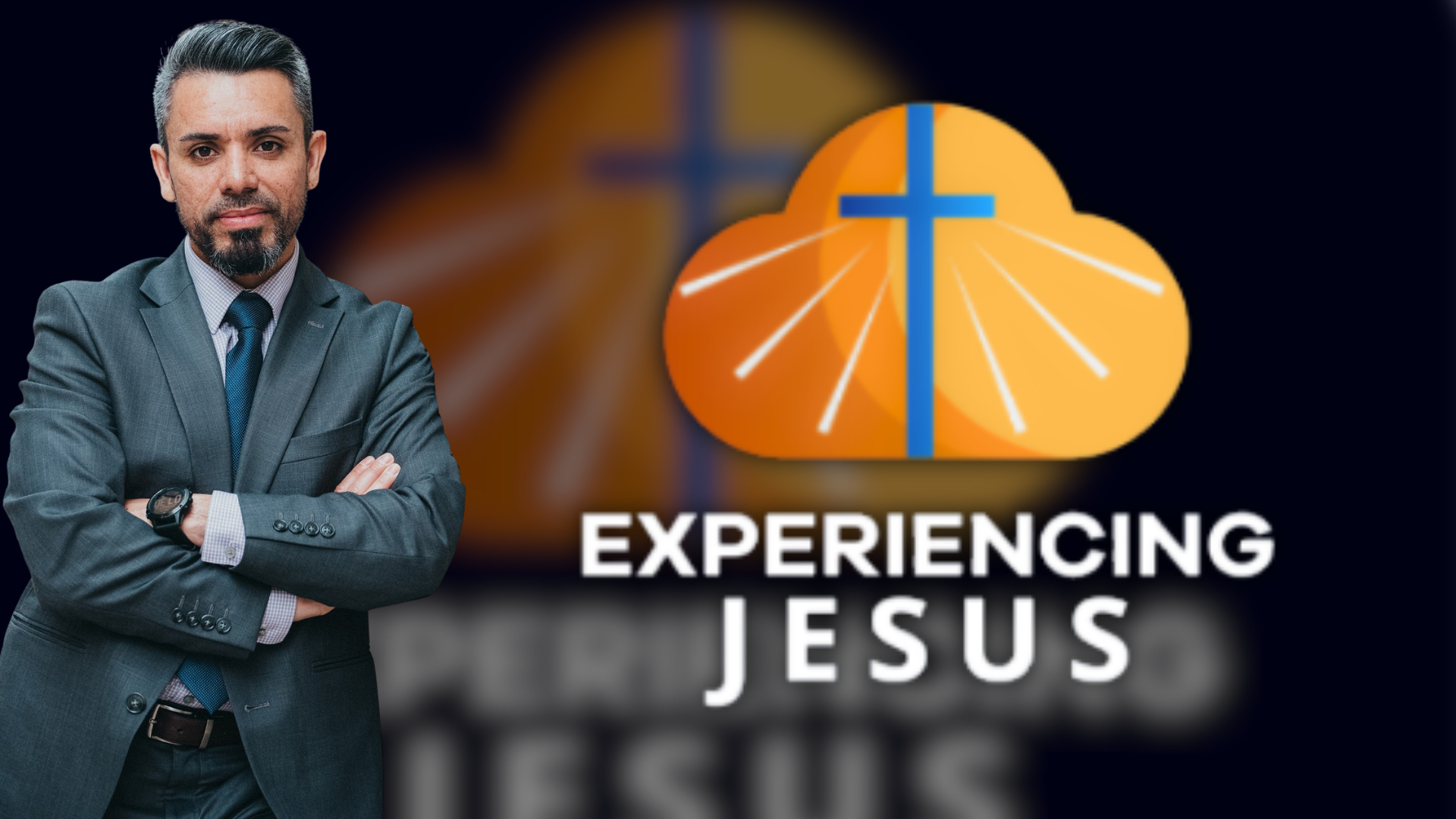 A promotional image for the show "Experiencing Jesus". The host of the show in a gray suit with arms crossed standing in front of a graphic of an orange cloud with a blue cross and white lines, and the text "Experiencing Jesus"