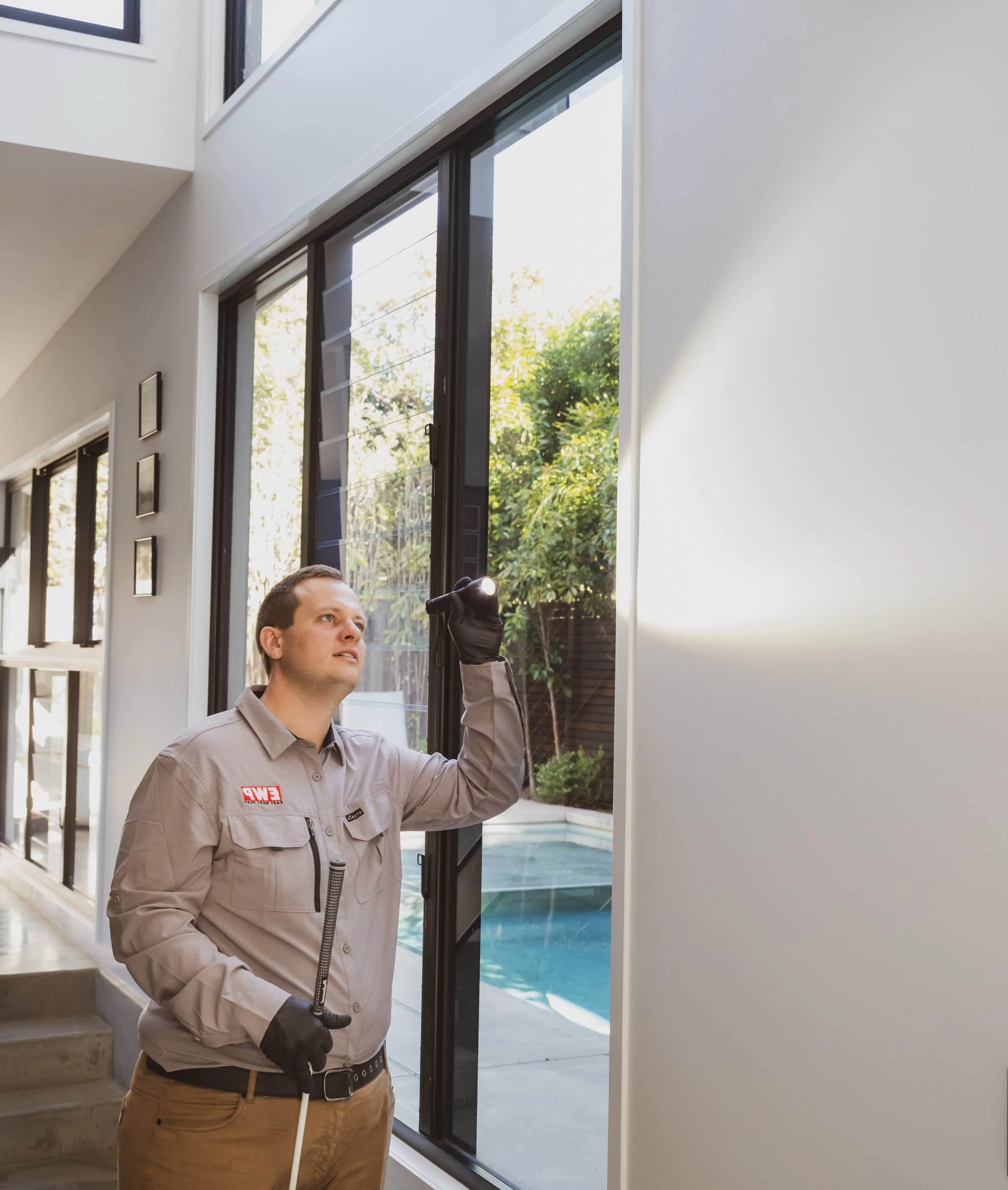 andrew inspecting a plasterboard during a white ant inspection ipswich