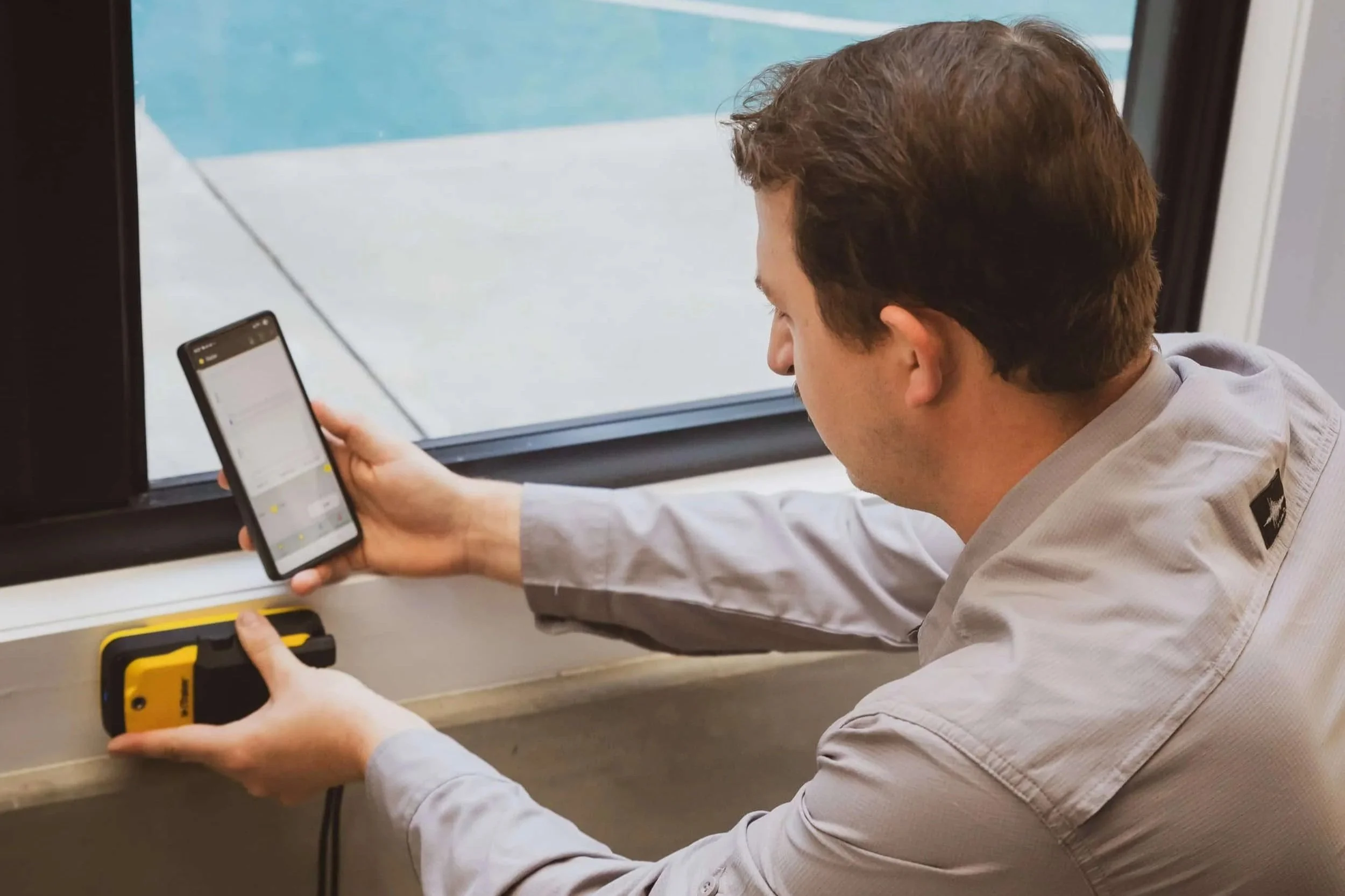 Pest control technician using Termatrac device during internal termite inspection – East West Pest.