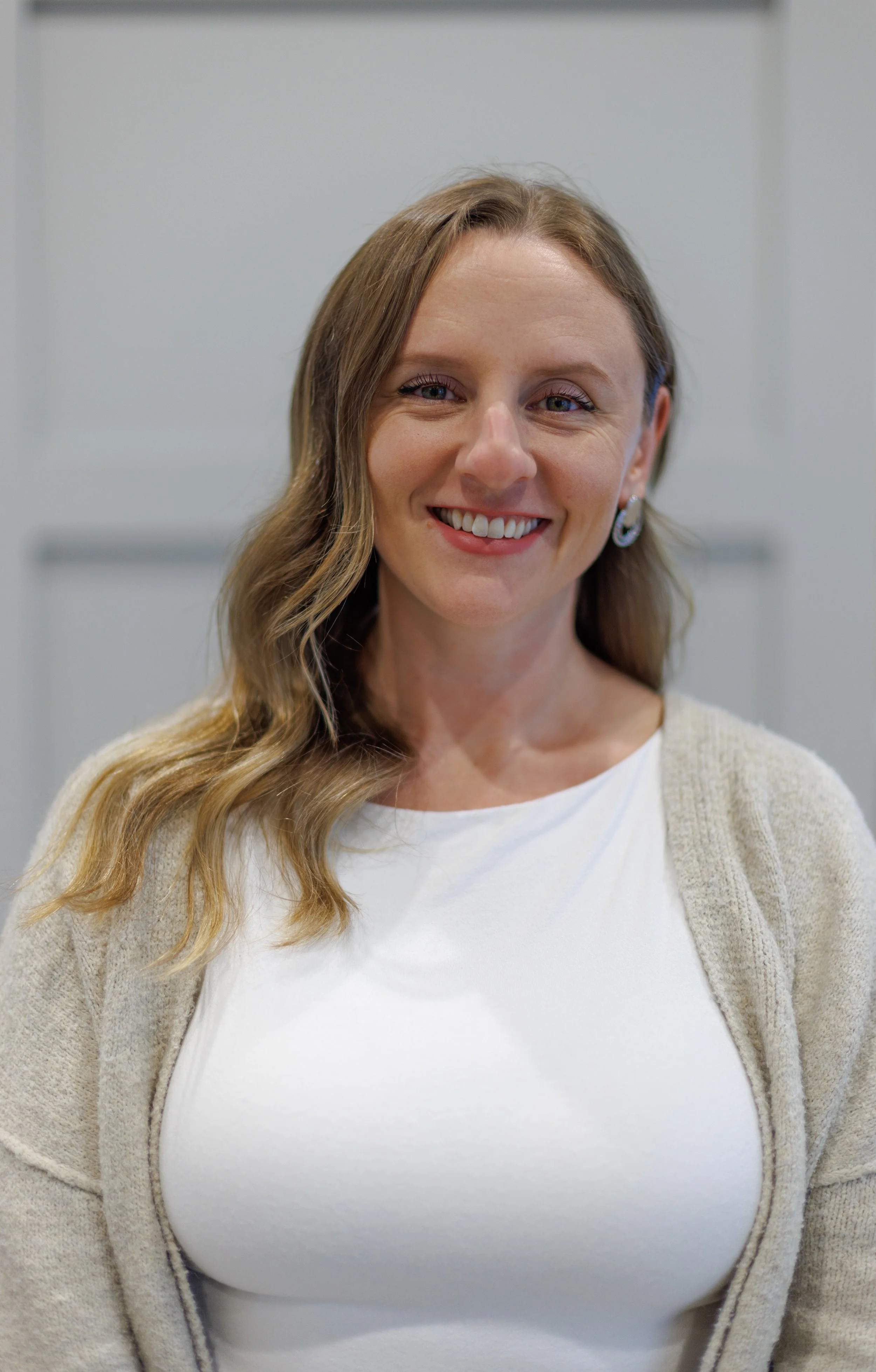 female therapist with light brown hair smiling at the camera