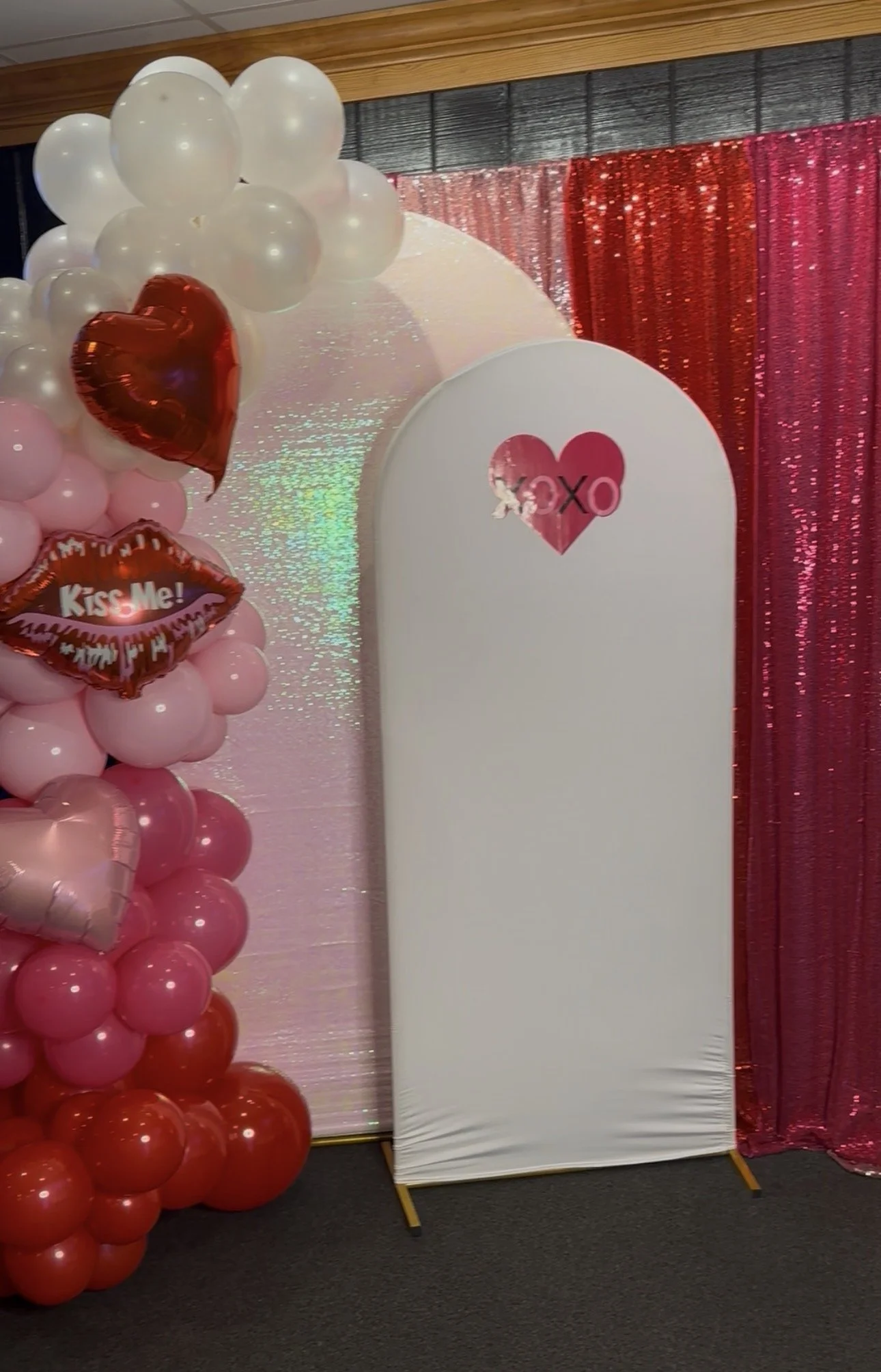 Honyes Booth Valentines Day Photo Booth rental set up in Hampton Roads Virginia with Red, White/opal, Dark & Light Pink Valentine's Day balloon arch. 