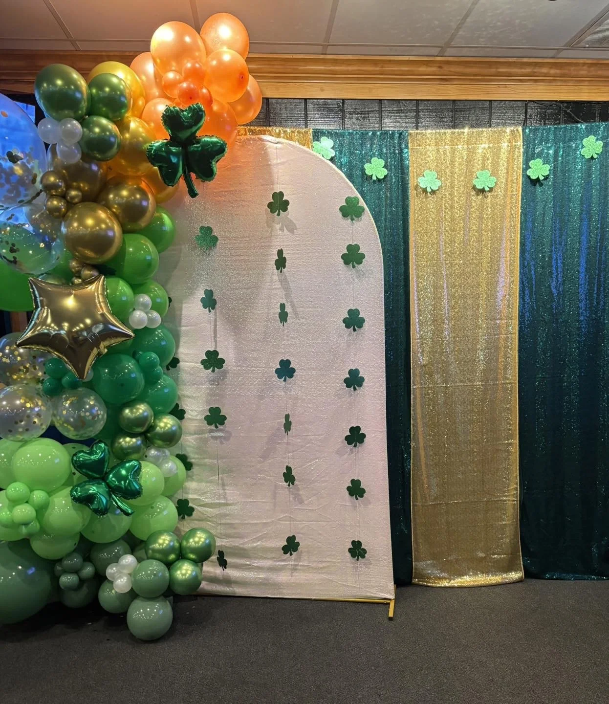 Honyes Booth St Patricks Day Photo Booth rental set up in Hampton Roads Virginia with dark & light green & gold St Patty's Day balloon arch. 