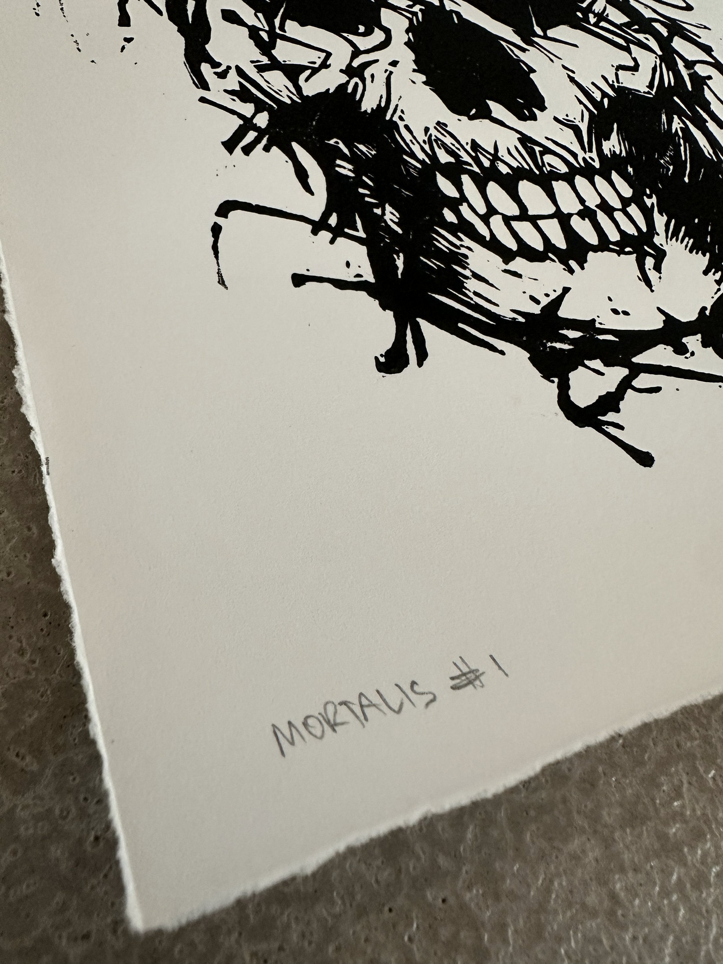Close-up detail of Mortalis #1 showing the hand-written title and edition number on textured cotton rag paper by Matt Wolfe
