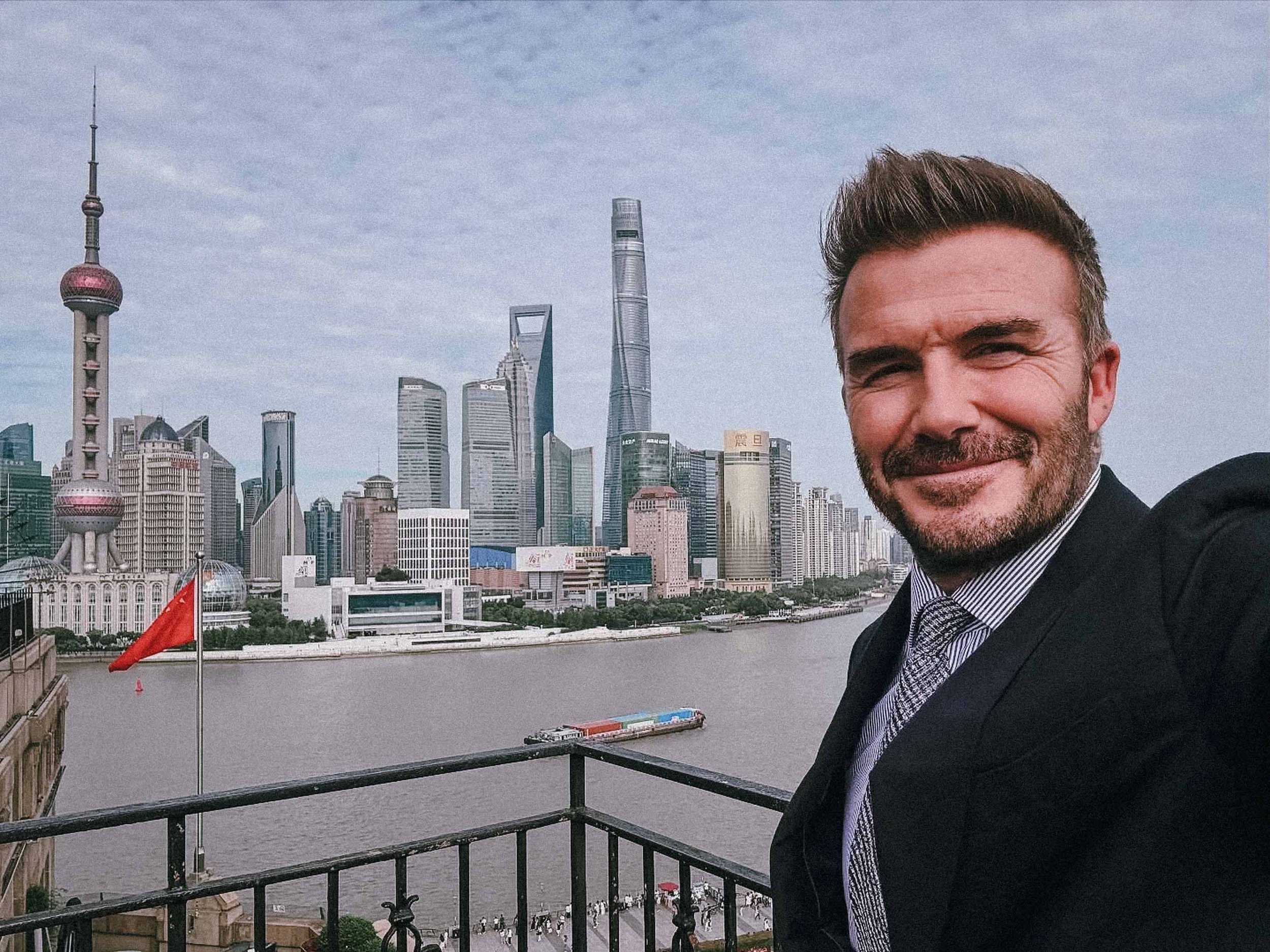 David Becham taking a selfie with Shanghai skyline in the background.