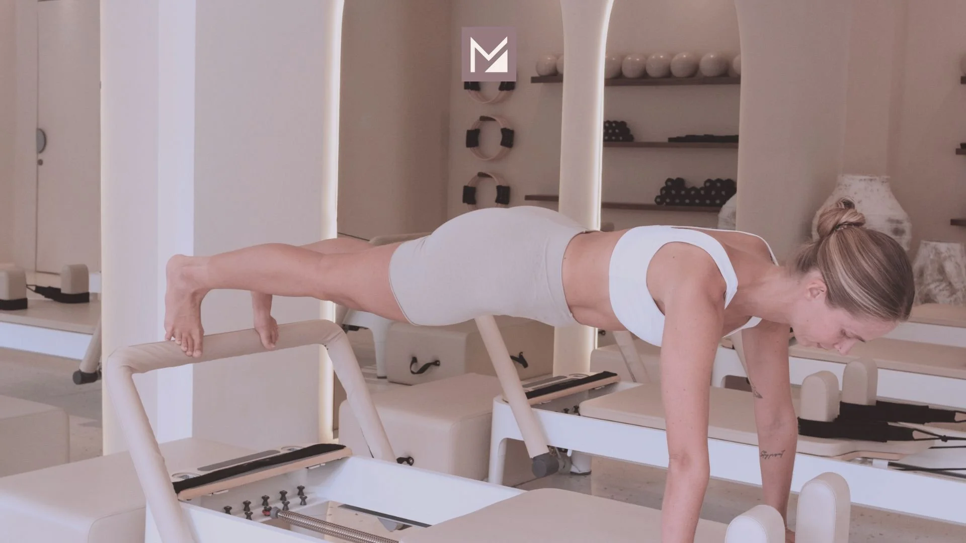 Woman training to do Reformer Pilates