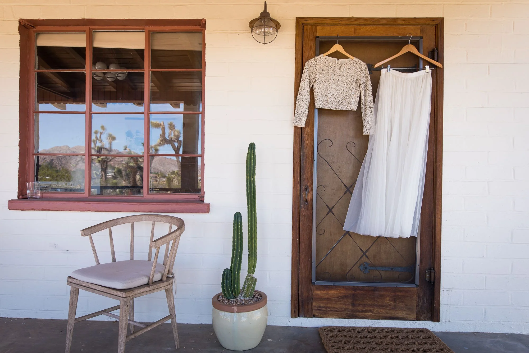 Wedding dress hanging on the porch of a desert casita in Joshua Tree